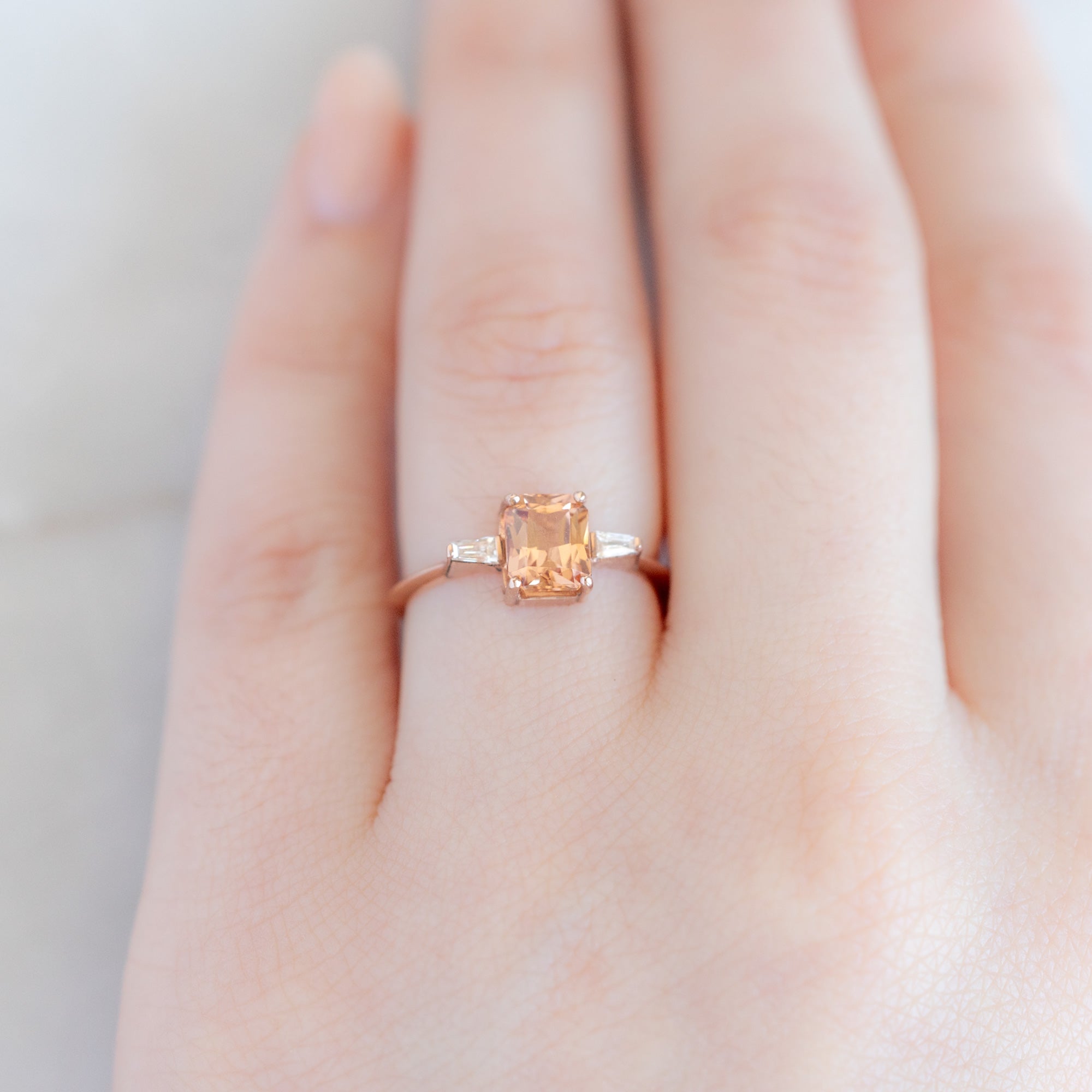 The Ash Ring | 1.43ct Emerald Cut Garnet in 14K Rose Gold displayed on model's left hand ring finger 