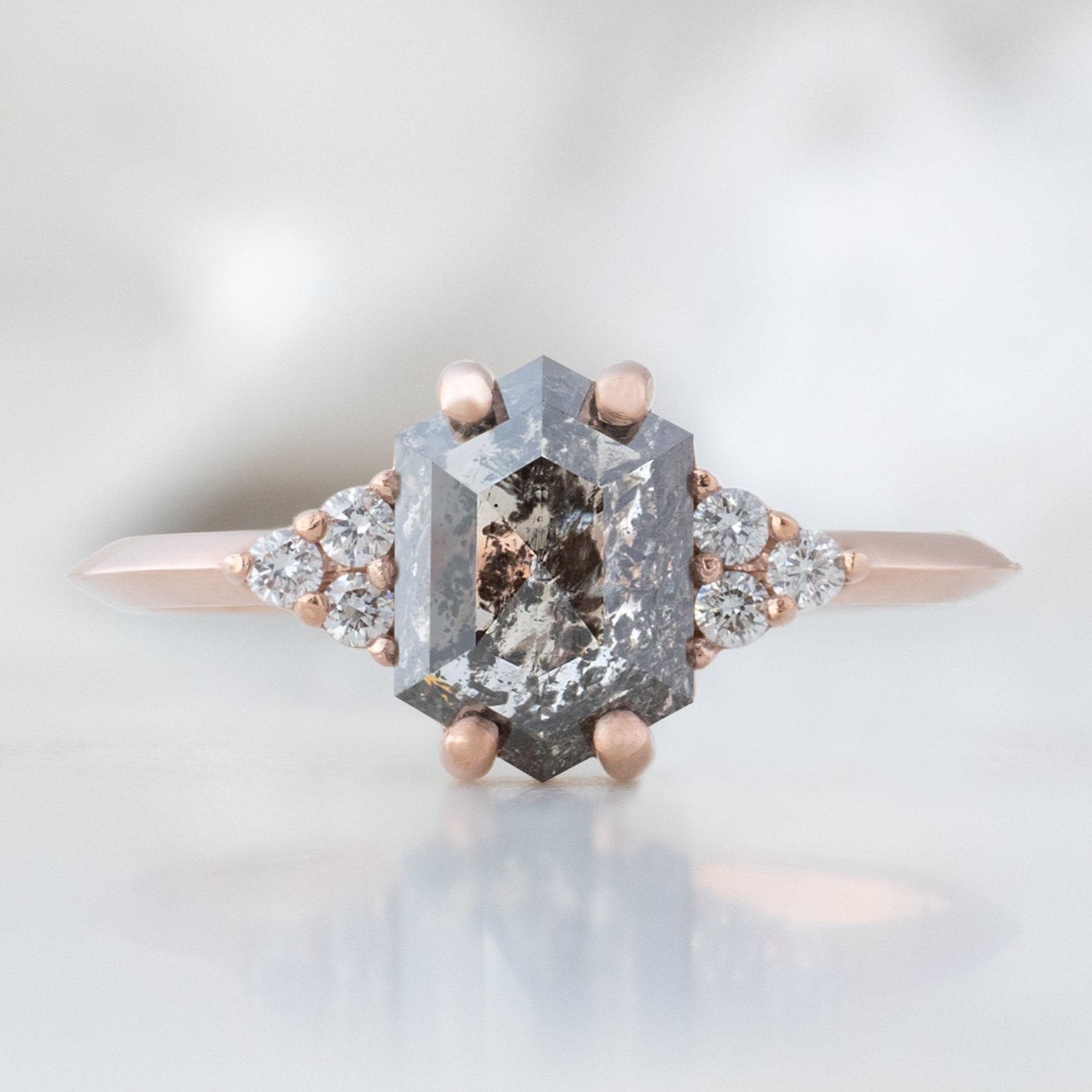 The Ivy Ring with a 1.49ct Hexagon Salt and Pepper Diamond in 14K Rose Gold on White Marble