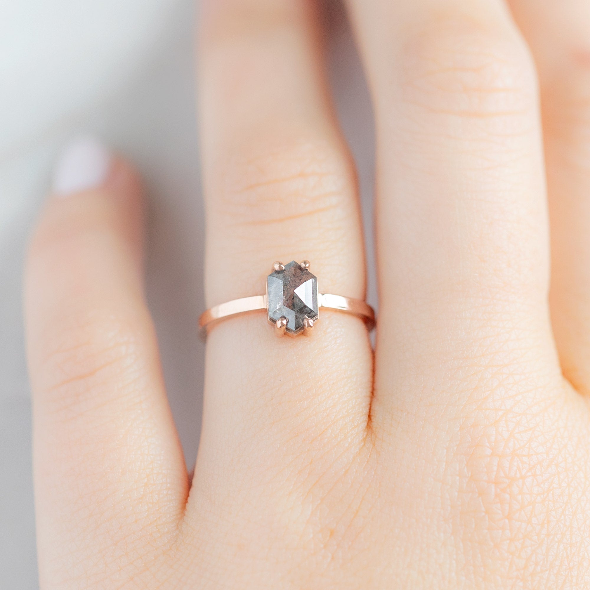 The Bryn Ring | 0.88 carat Black Hexagon Diamond in 14K Rose Gold displayed on model's left hand ring finger. 