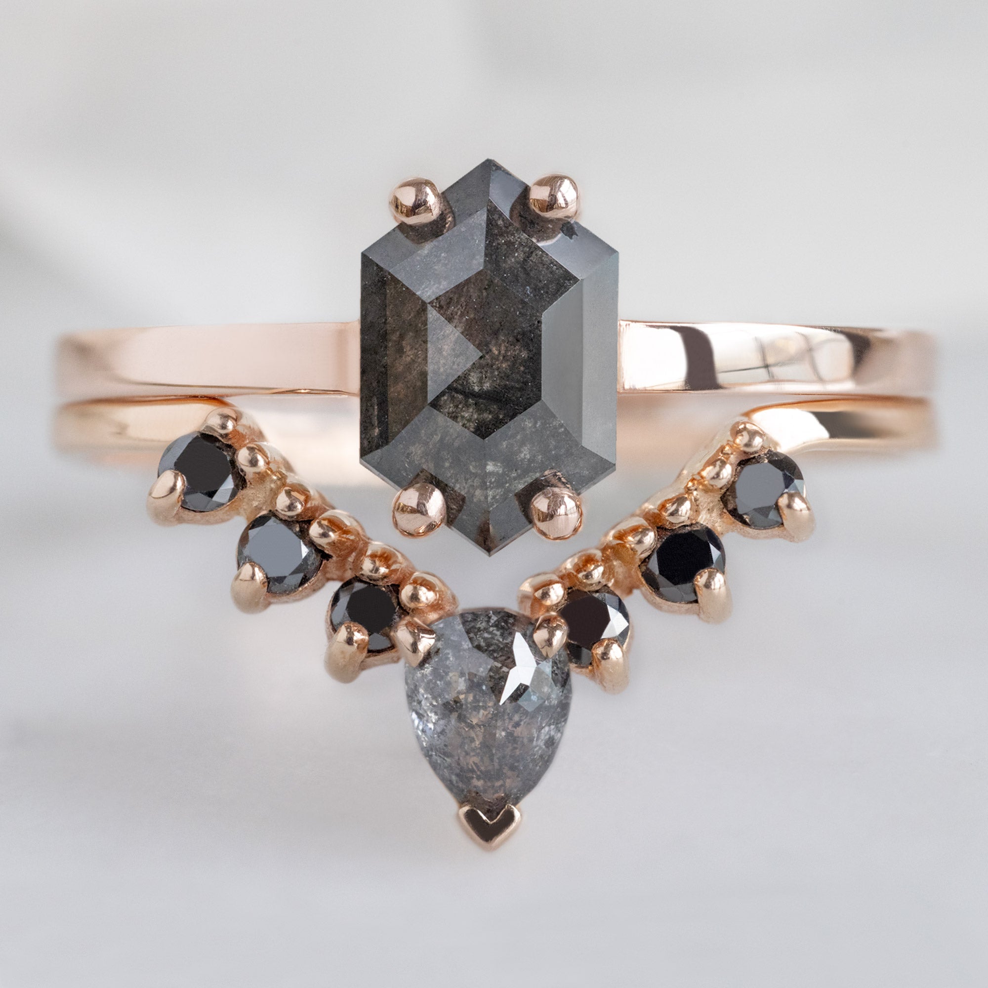 The Bryn Ring with a 0.88 carat Black Hexagon Diamond in 14K Rose Gold Stacked with Black Diamond Sunburst Stacking Band