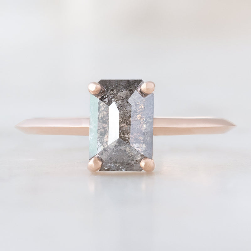 The Bryn Ring with a 1.26ct Emerald Cut Salt and Pepper Diamond in 14K Rose Gold on white background