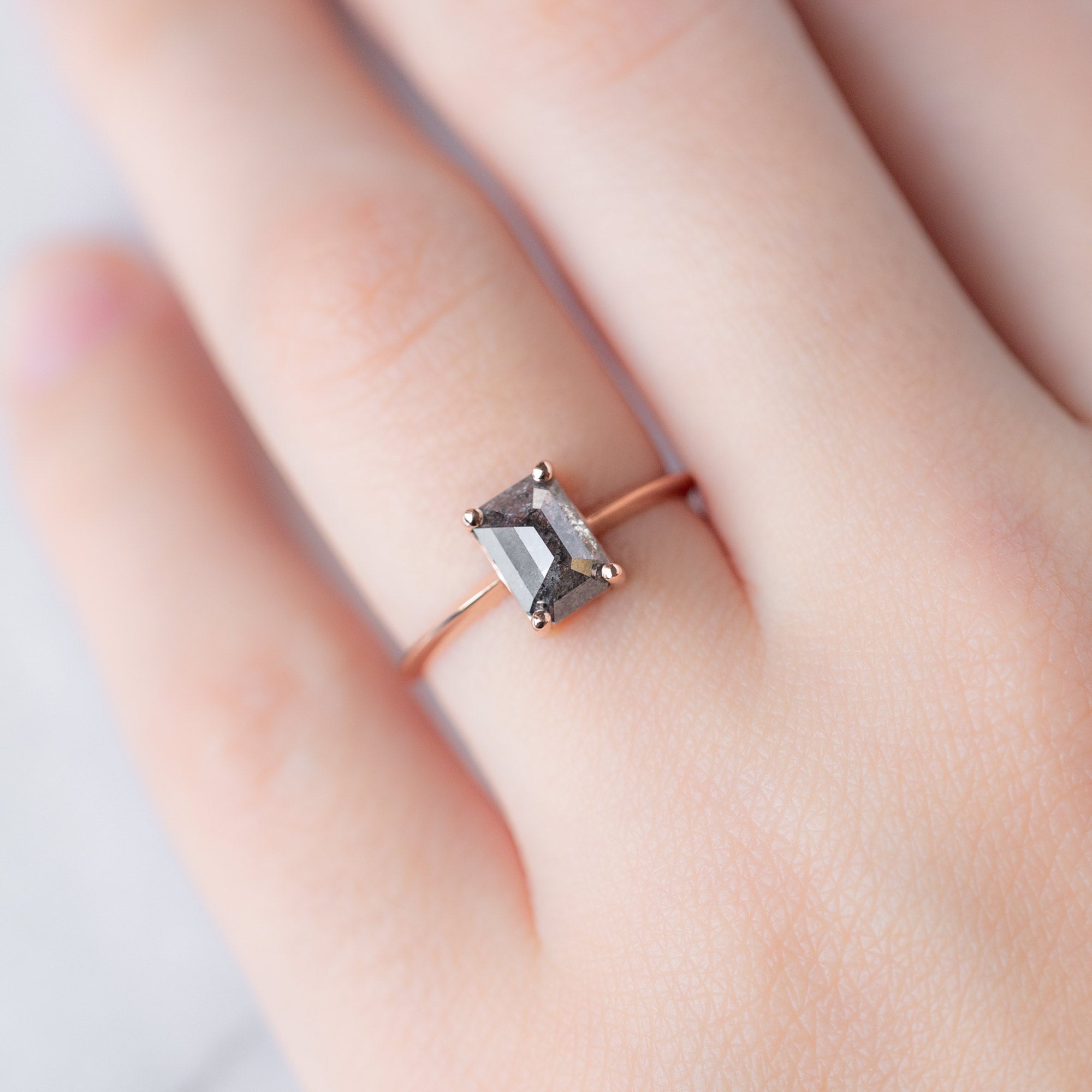 The Bryn Ring with a 1.26ct Emerald Cut Salt and Pepper Diamond in 14K Rose Gold on model