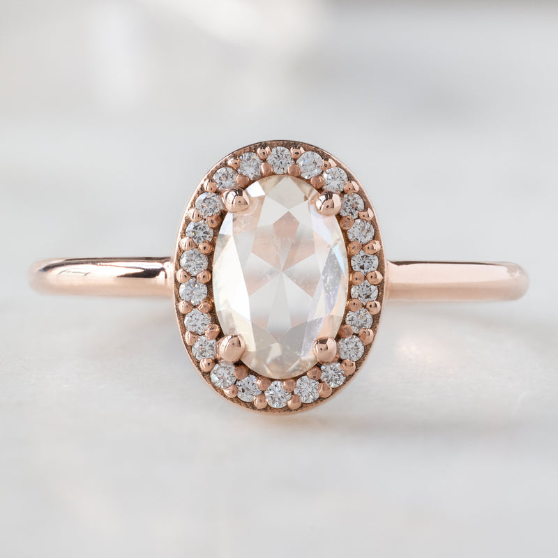 The Dahlia Ring with a 0.87ct Oval Pink Diamond in 14K Rose Gold on white background