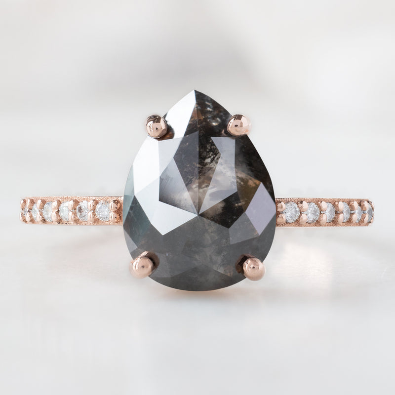 The Willow Ring with a 2.01ct Pear Black Diamond in 14K Rose Gold on White Marble