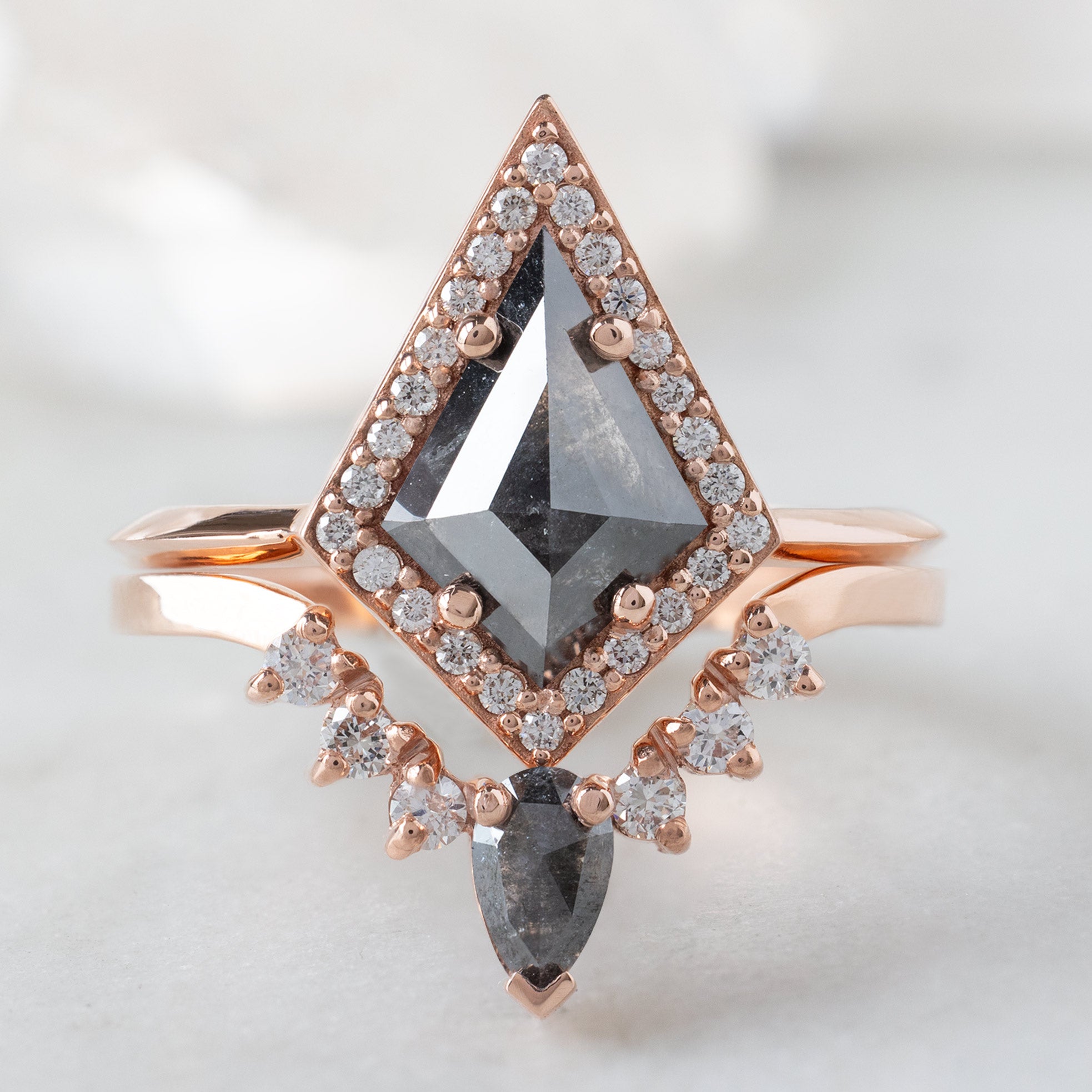 The Dahlia Ring with a 0.89ct Black Kite Diamond in 14K Rose Gold Stacked with the Black and White Diamond Sunburst Stacking Band