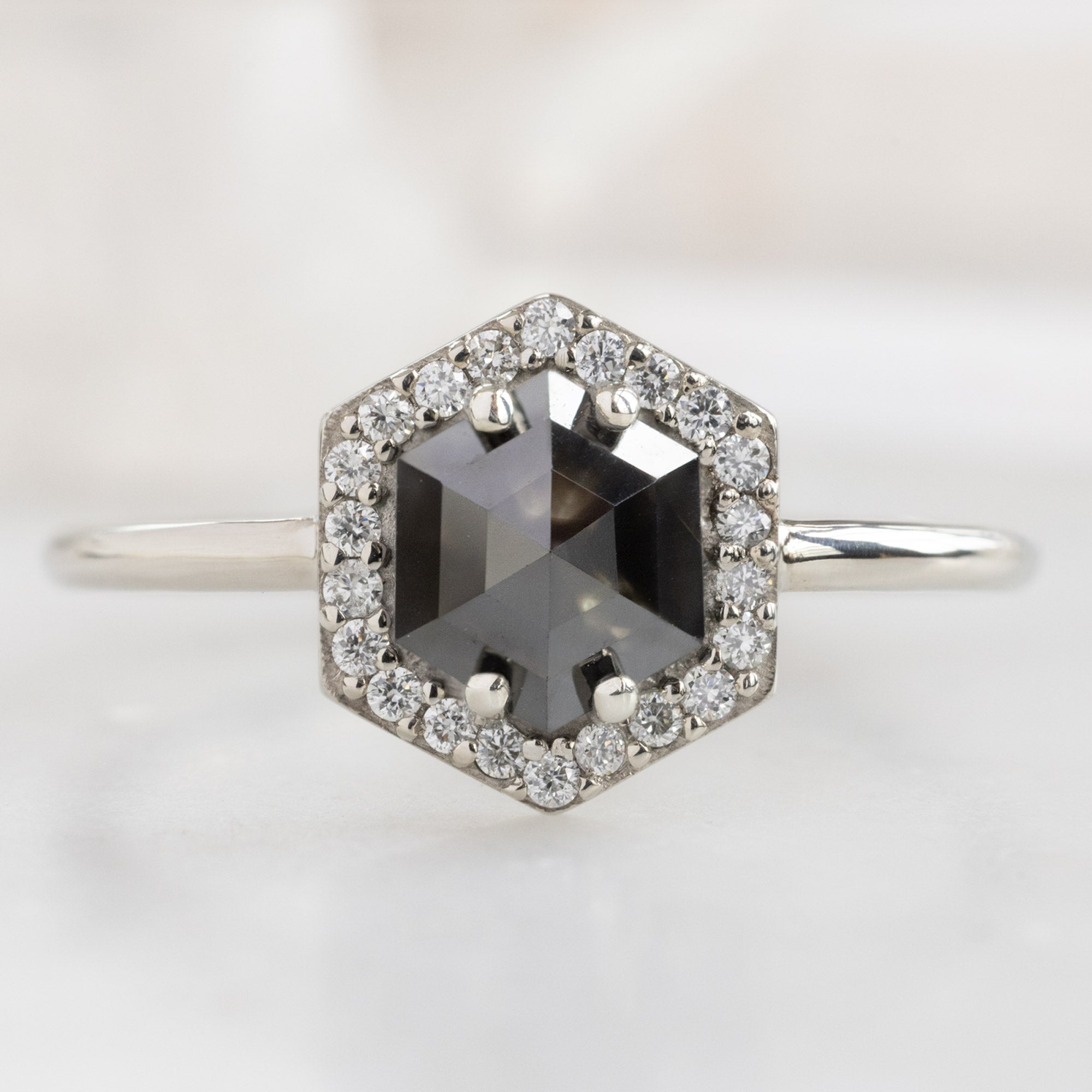 The Dahlia Ring with a 1.38ct Hexagon Black Diamond in 14K White Gold on White Marble