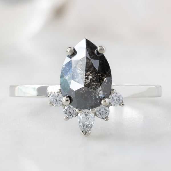 The Aster Ring with a 1.55ct Pear Black Diamond in 14K White Gold on White Marble