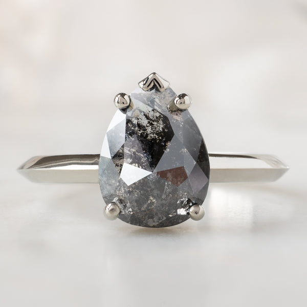 The Sage Ring with a 1.83ct Pear Black Diamond in 14K White Gold on White Marble