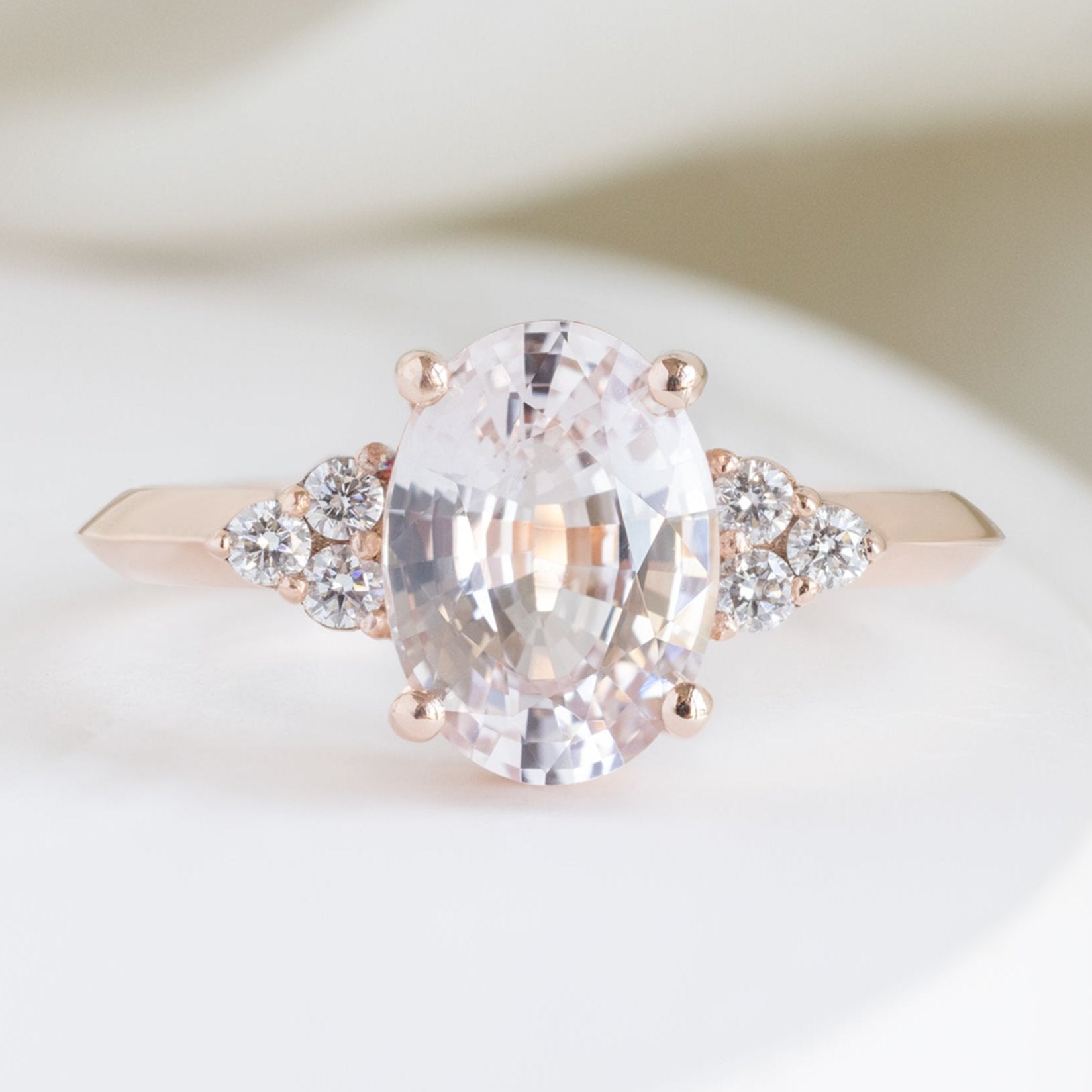 The Ivy Luxe with a 2.12ct Oval Peach Sapphire in 18K Rose Gold on White Marble