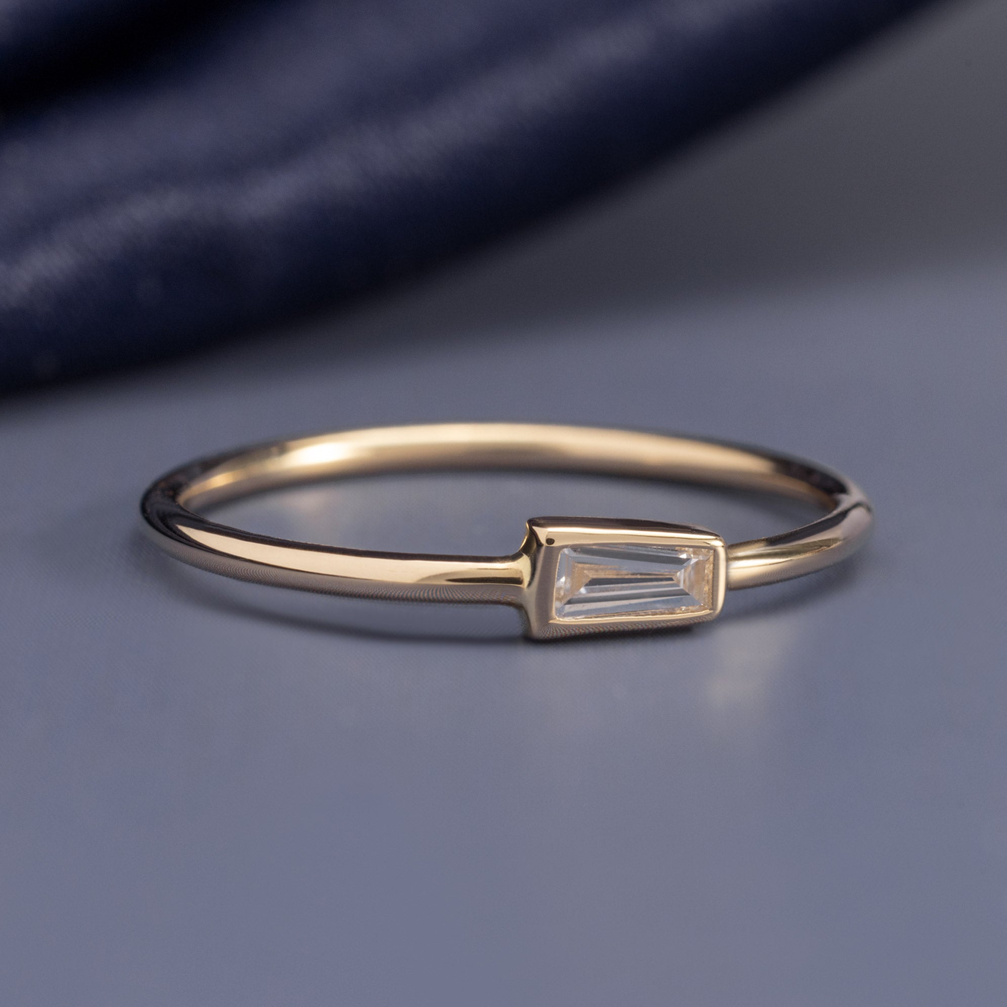 Baguette Diamond Stacking Ring in 10K Yellow Gold on Blue Background