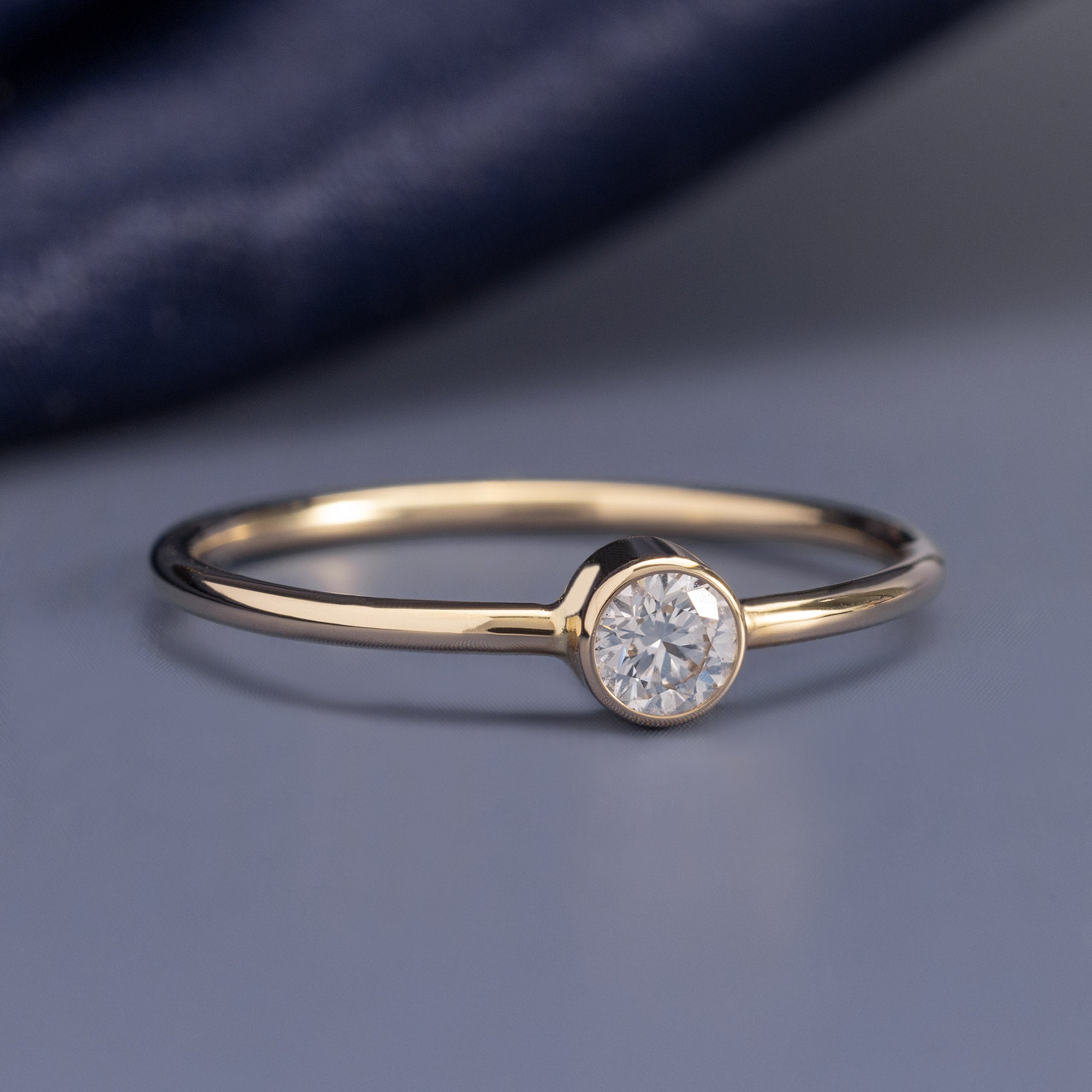 Round-Cut Lab Grown Diamond Stacking Ring in 10K Yellow Gold on Blue Background