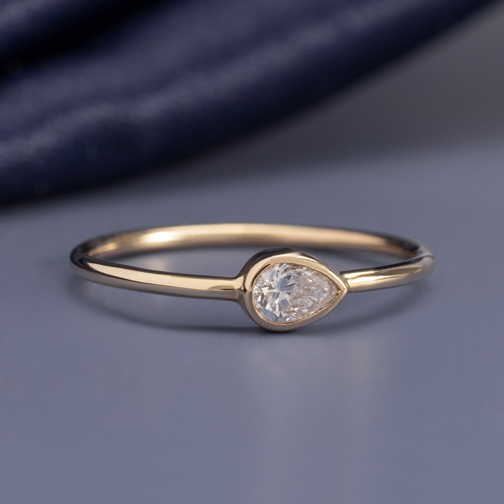 Pear-Cut Lab Grown Diamond Stacking Ring in 10K Yellow Gold on Blue Background