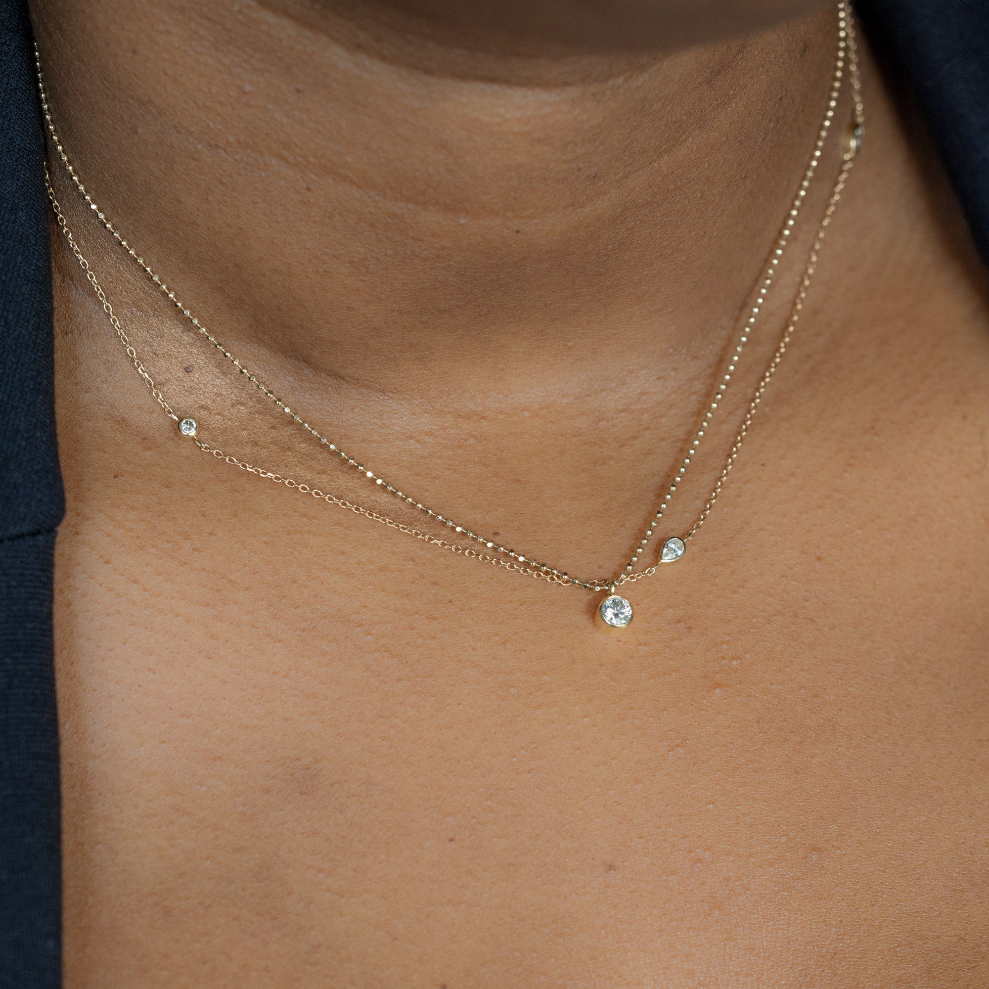 Pear-Cut Diamond Chain and ‘Not Your Typical Solitaire’ Diamond Necklaces in 10K Yellow Gold layered on model