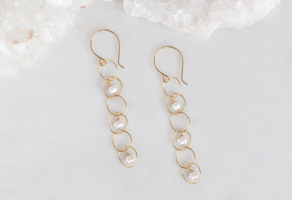 Pearl Party Drop Earrings on White Marble Tile