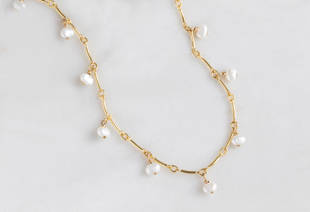 Pearl Party Station Necklace on White Marble Tile