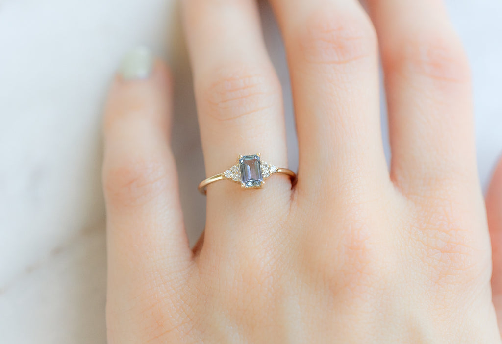 The Ivy Ring with an Emerald-Cut Tanzanite on Model