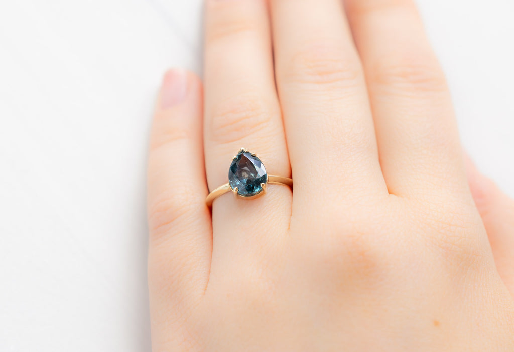 The Sage Ring with a Pear-Cut Montana Sapphire on Model