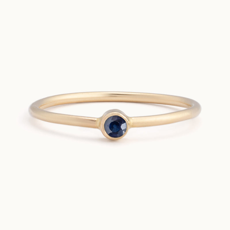 Custom Blue Sapphire Birthstone Stacking Ring | 10K Yellow Gold with white background. 