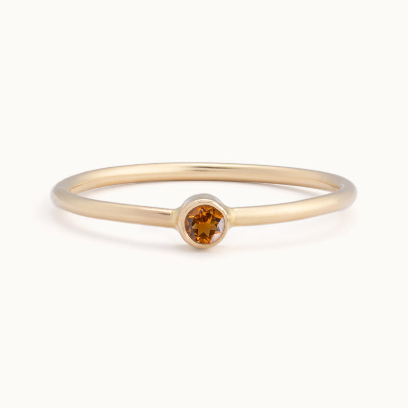 Custom Citrine Birthstone Stacking Ring | 10K Yellow Gold with white blurred background.