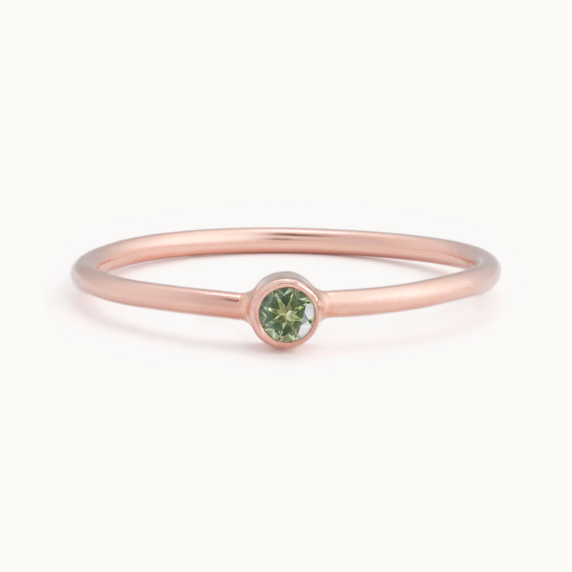 Custom Peridot Birthstone Stacking Ring | 10K Rose Gold with white background. 