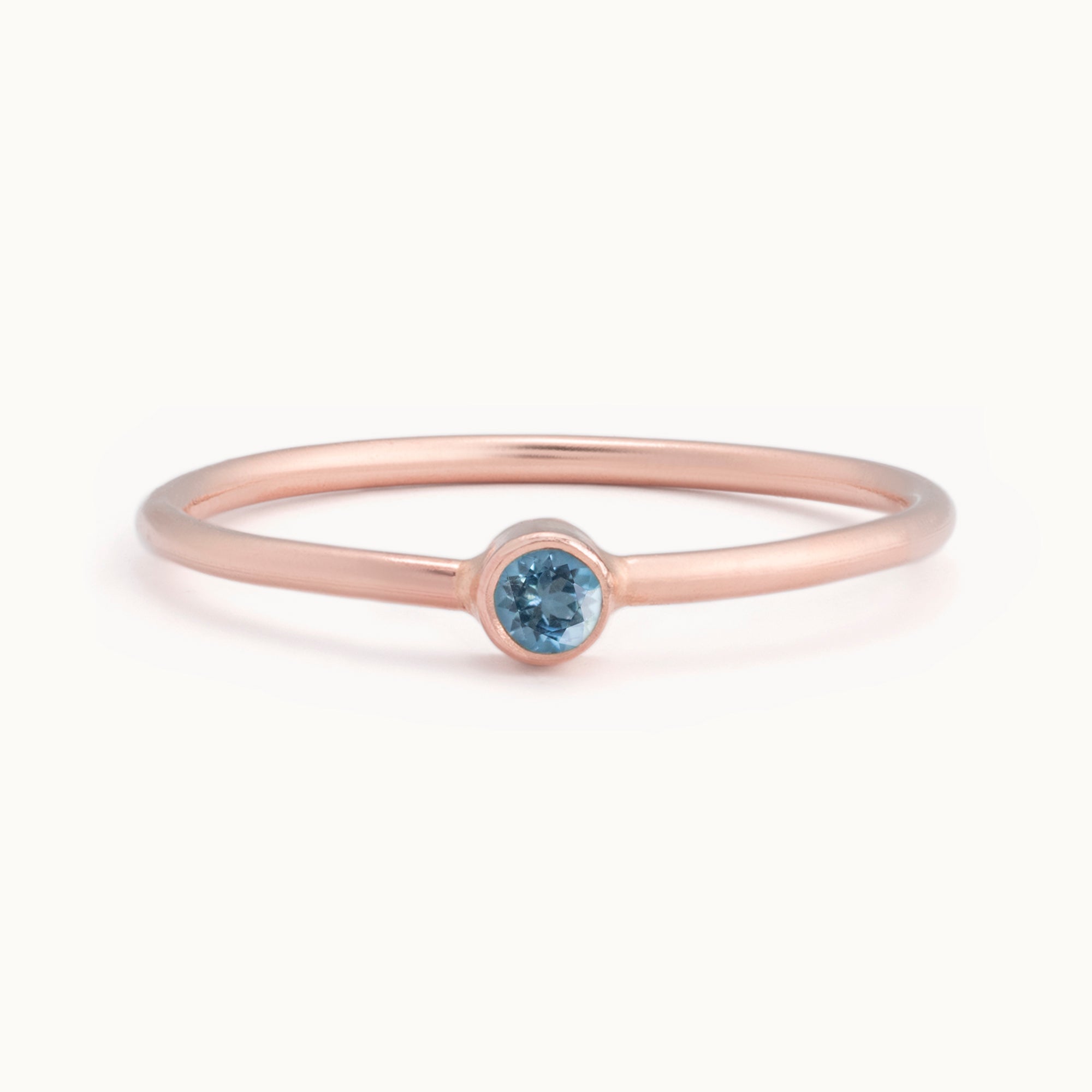 Custom Aquamarine Birthstone Stacking Ring | 10K Rose Gold with white background. 