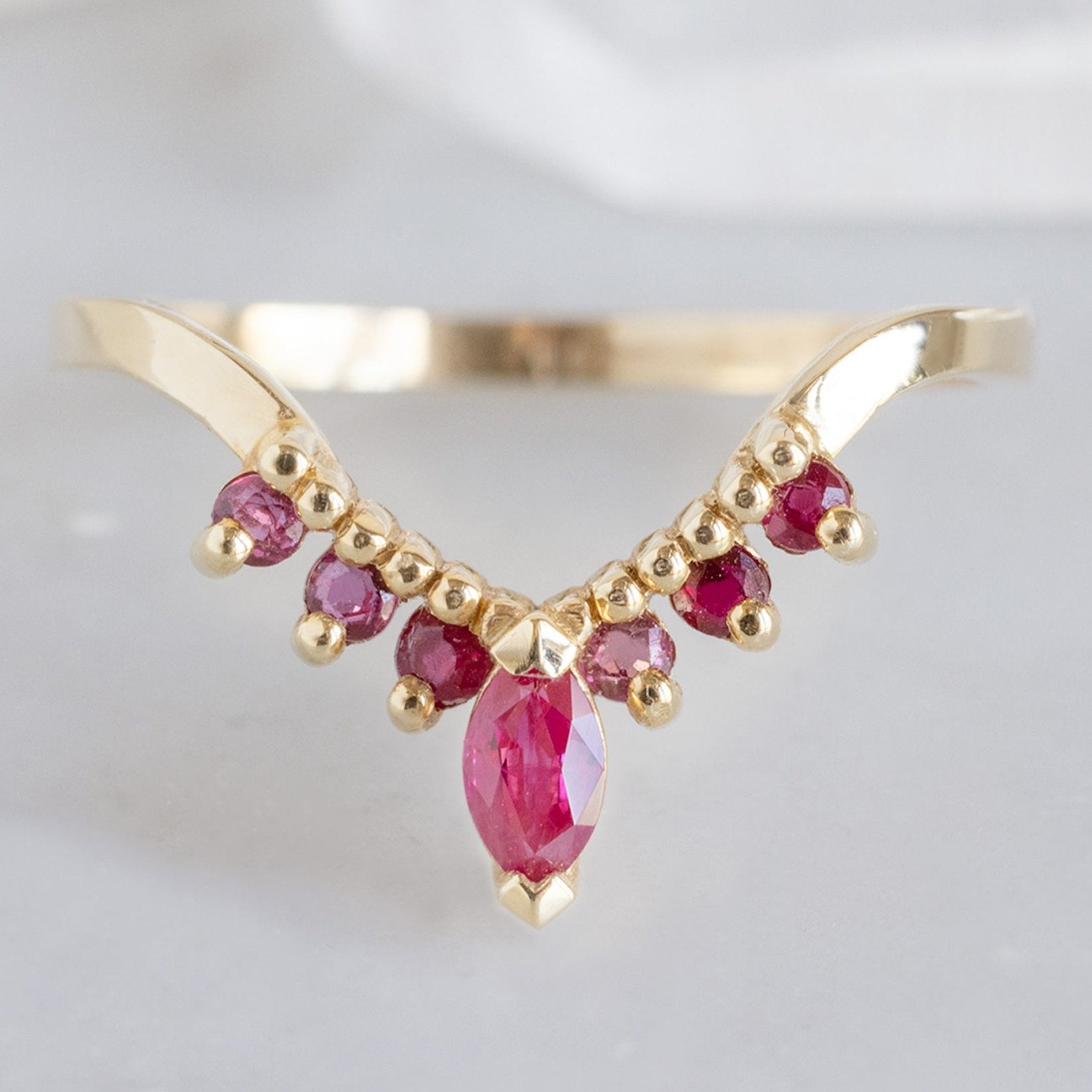 One of a Kind Marquise Ruby Sunburst Stacking Band in Yellow Gold on White Marble