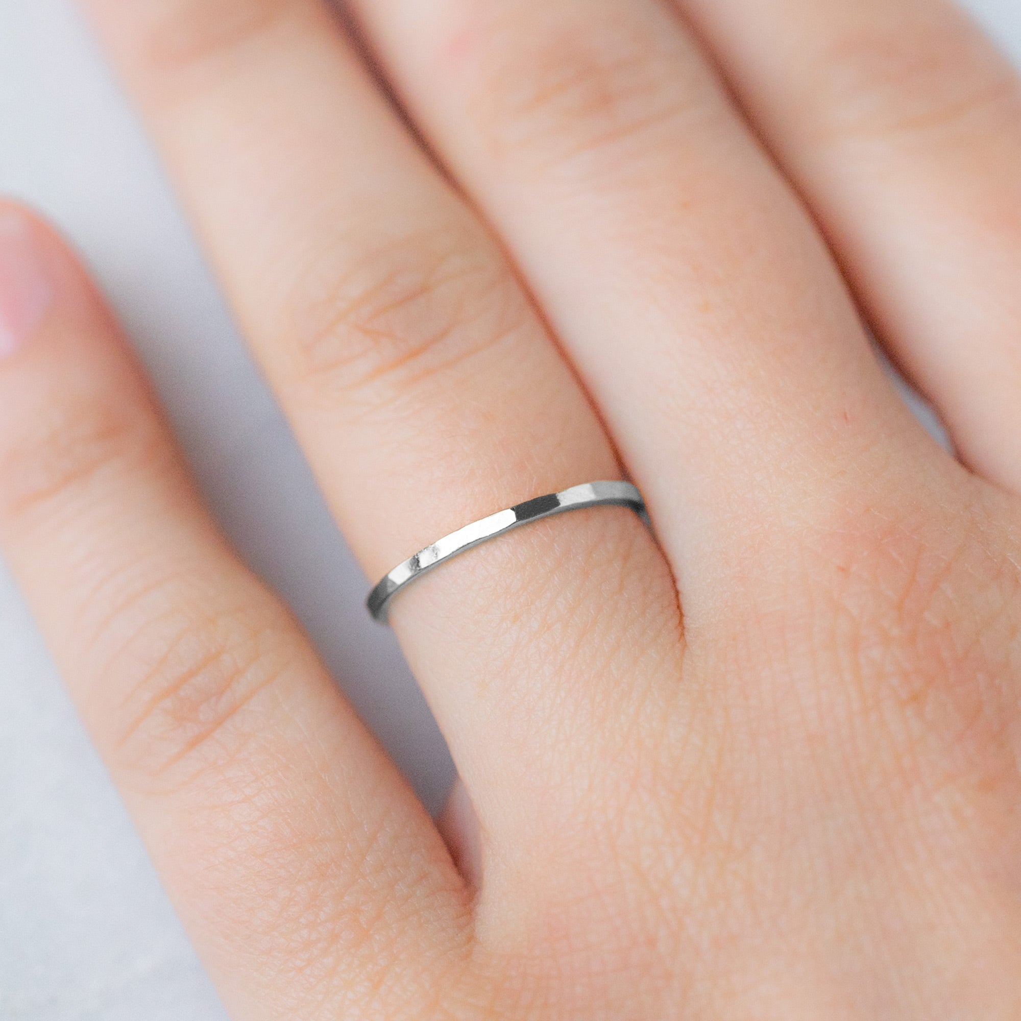 The Gold Stacking Wedding Ring | Hammered Texture in 14K White Gold displayed on model's left hand ring finger.