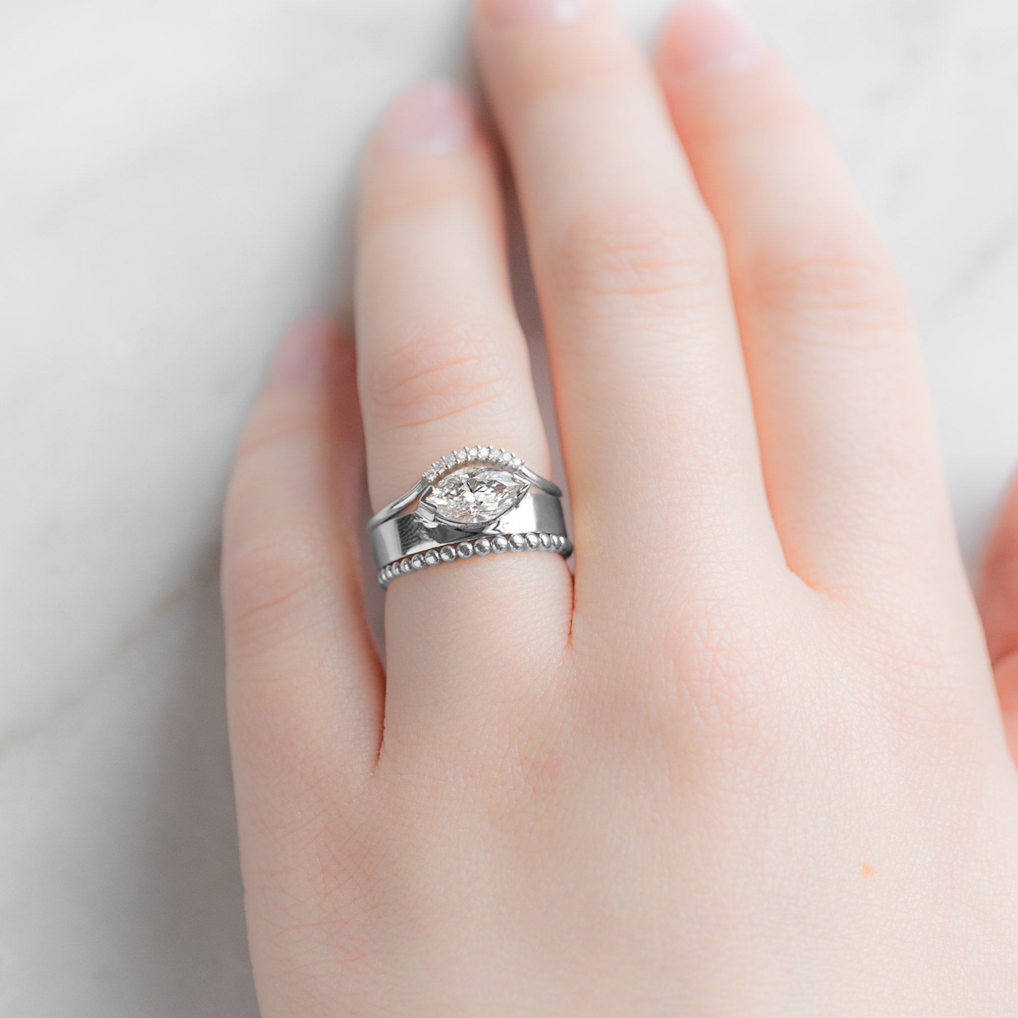 The Gold Beaded Stacking Ring in 14K White Gold Stacked with White Diamond Engagement Ring on Model