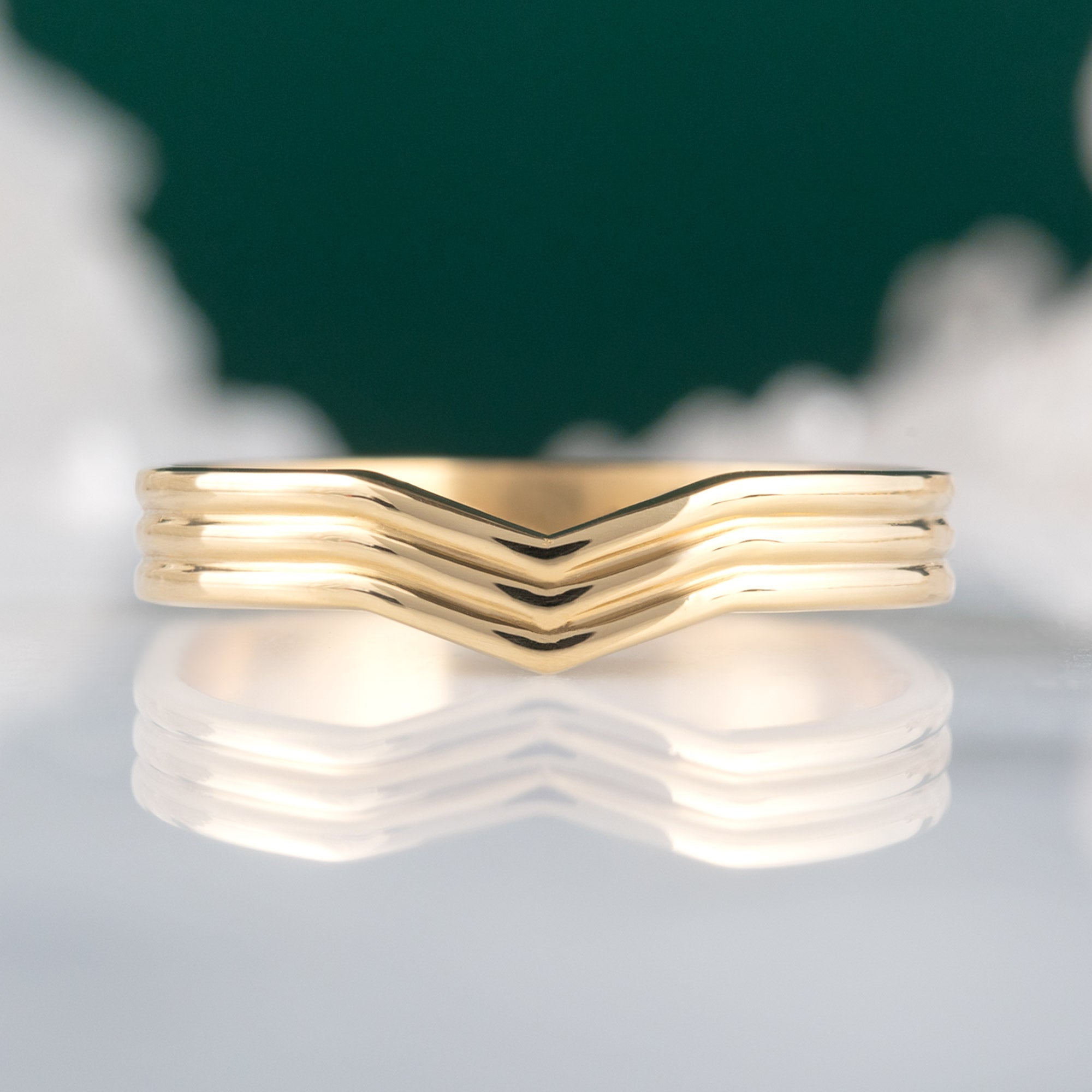 Custom Peak Stratum Stacking Band | 18K Yellow Gold displayed on marble surface.