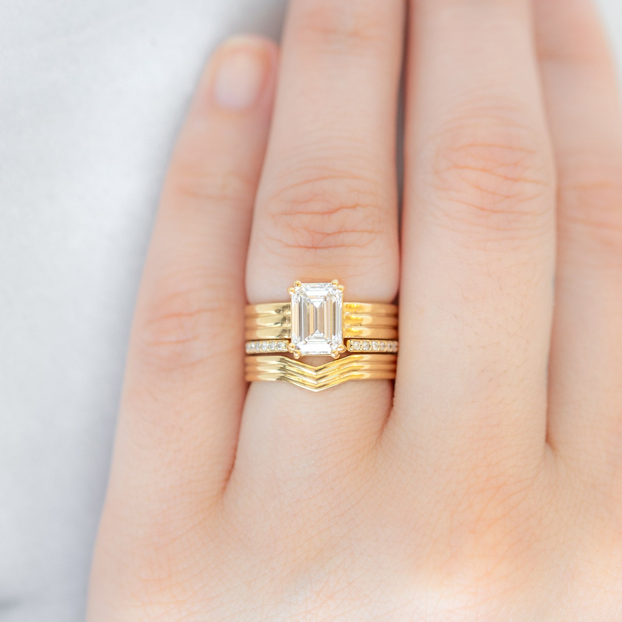 Custom Peak Stratum Stacking Band | 18K Yellow Gold paired with two other rings on model's left hand ring finger.