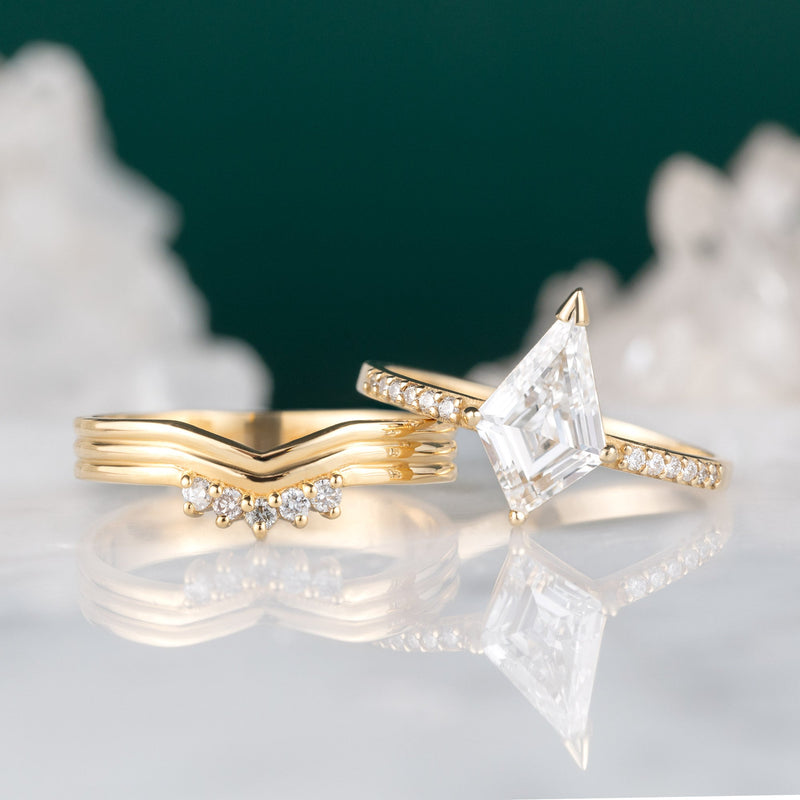 Custom Peak Stratum Stacking Band with Lab Grown Diamonds | 18K Yellow Gold next to kite cut engagement ring.