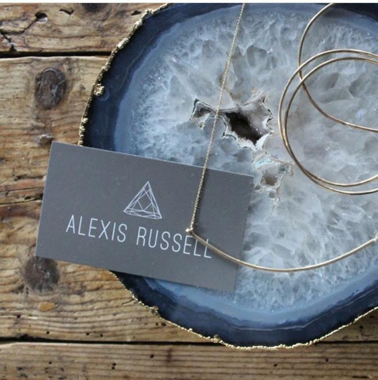 Alexis Russell business car on blue agate slice on wood table